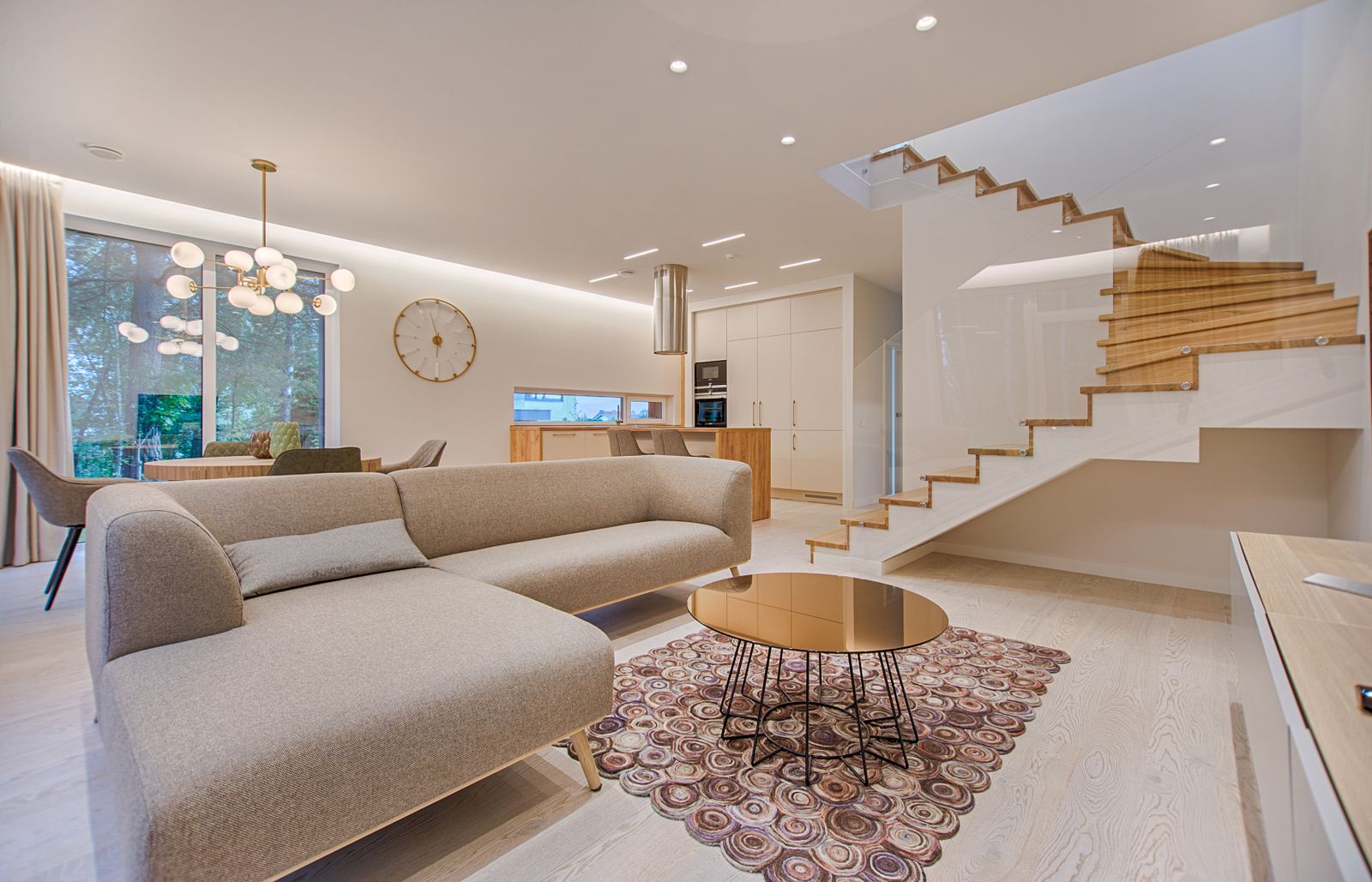 Finished open living space with wood stairs after a home renovation