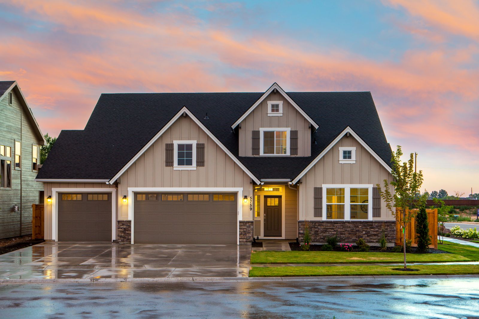 Craftsman-style home with siding, stone accents, and a dark shingle roof